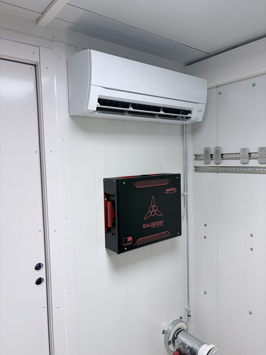 Wall-mounted air conditioning unit and automatic fire suppression unit
