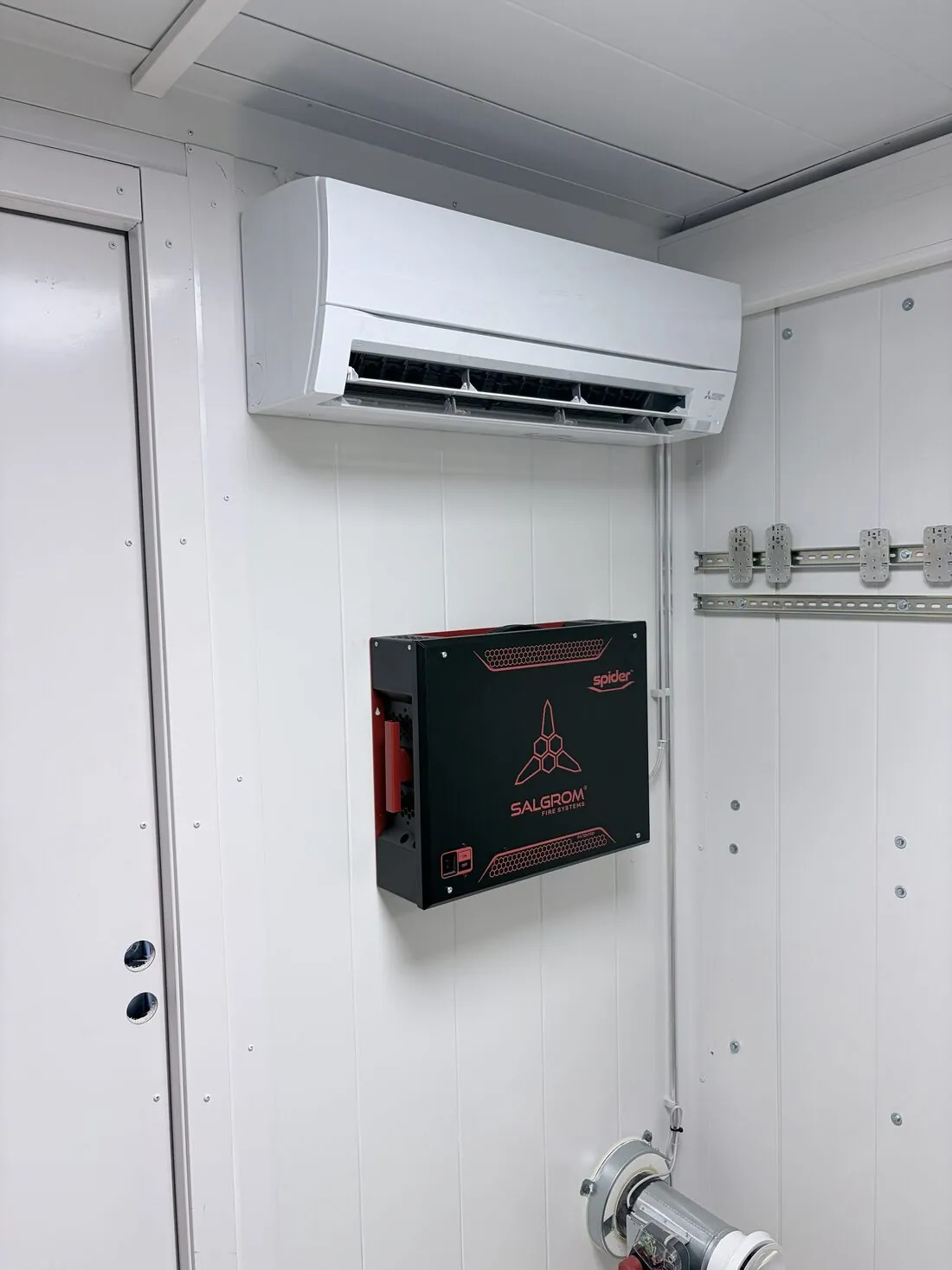 Wall-mounted air conditioning unit and automatic fire suppression unit
