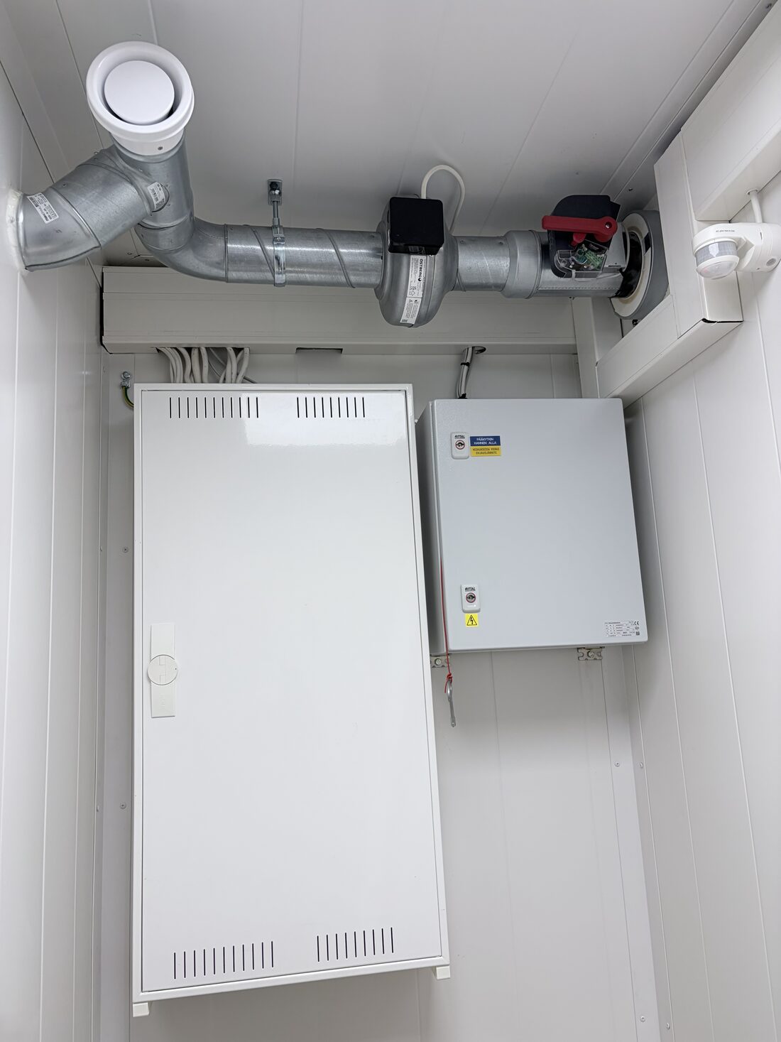 Electrical distribution cabinets and ventilation ductwork inside the container