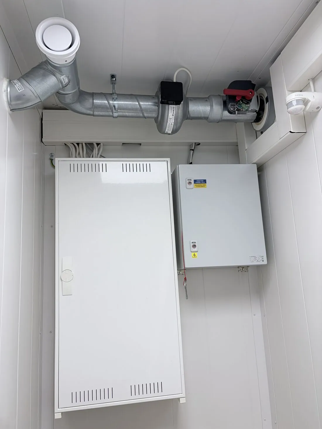 Electrical distribution cabinets and ventilation ductwork inside the container