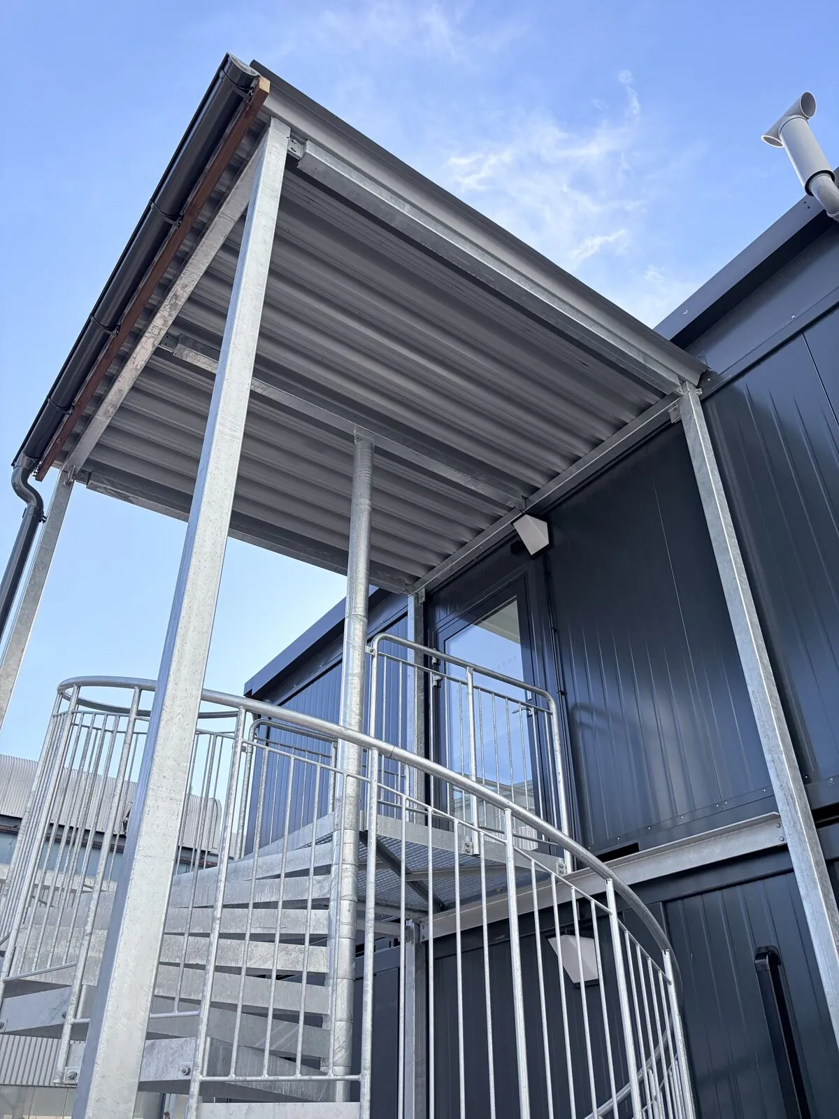 Galvanised access stairs and canopy on a modular building